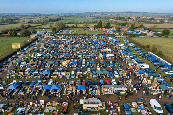 Aerial view of the Hook Road Arena car boot sale in Epsom with hundreds of car stalls and weekend shoppers