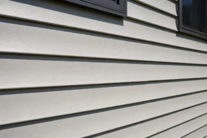 Close-up of clean horizontal vinyl siding panels on a modern suburban home exterior in daylight